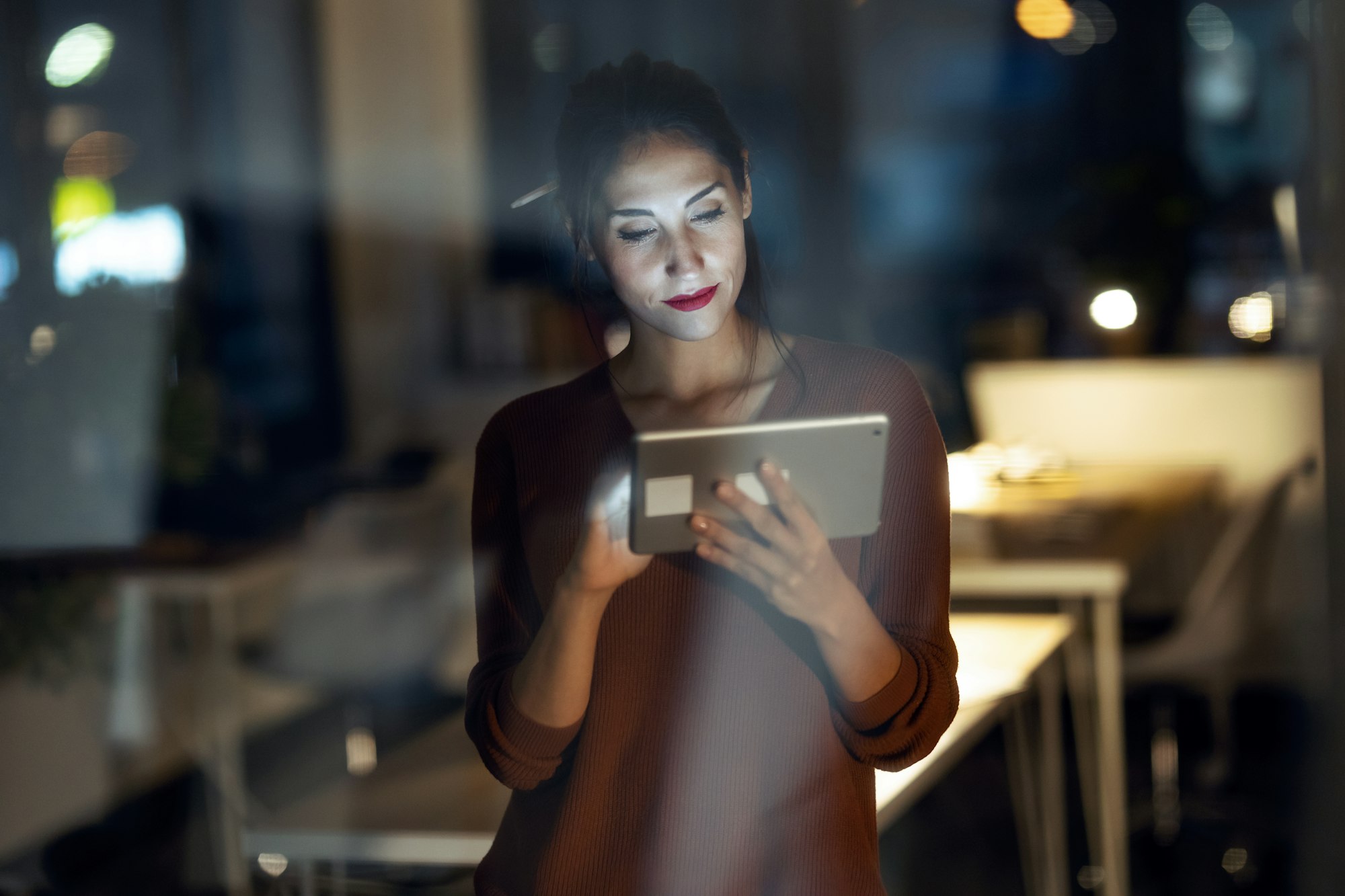 Smart pretty business woman taking a break cheaking her digital tablet in the office.